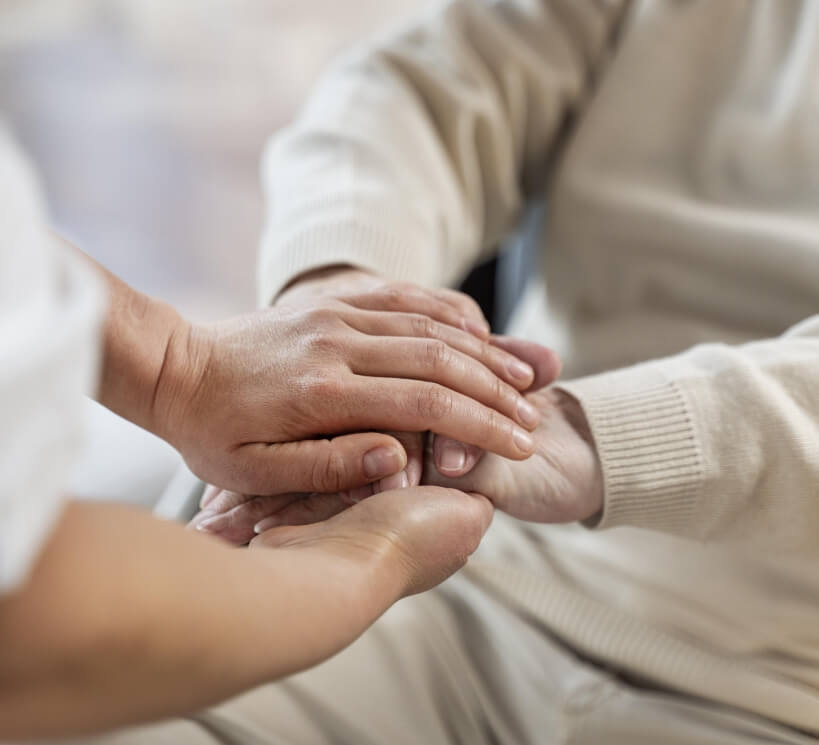 doctor holding hands with senior patient