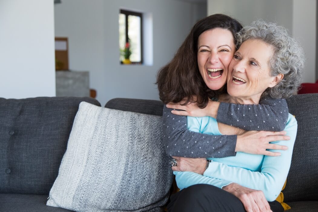 portrait happy mid adult woman embracing her senior mother